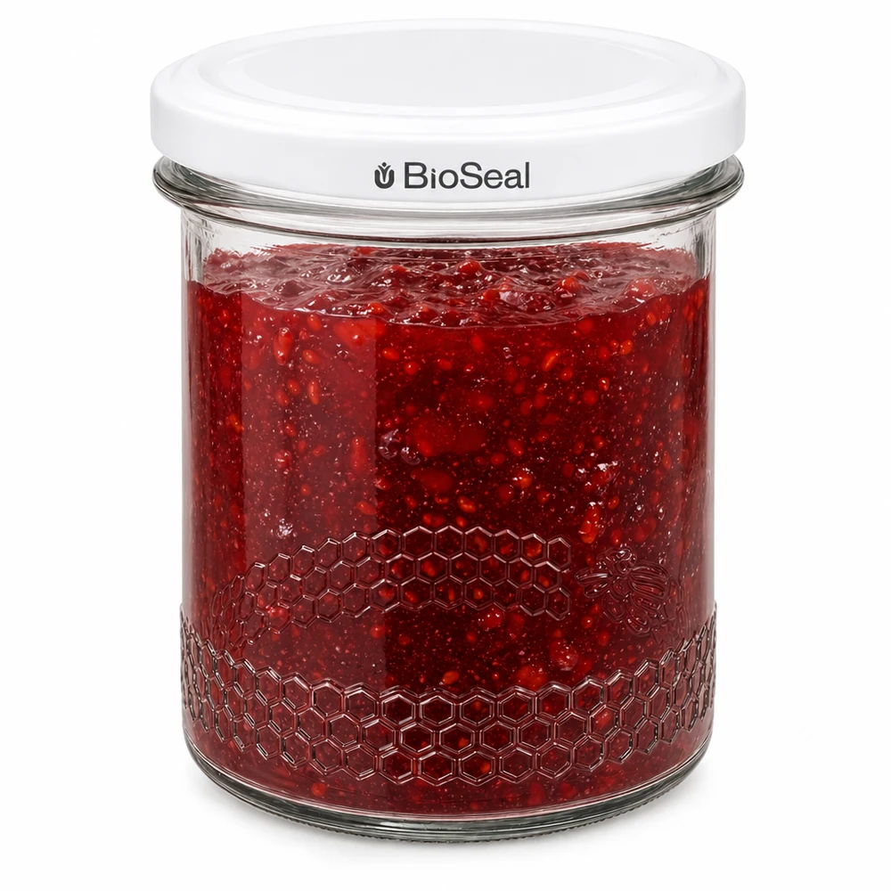 Pot à miel 560 g avec couvercle blanc BioSeal UNiTWIST BioSeal pot de 400ml rempli de confiture rouge montre une fermeture hermétique et un gaufrage en nid d'abeille sur le bord du pot