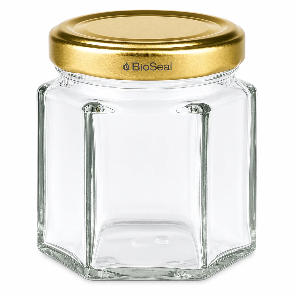Pot à miel hexagonal de 60g avec couvercle doré à visser BioSeal UNiTWIST pour miel et confiture